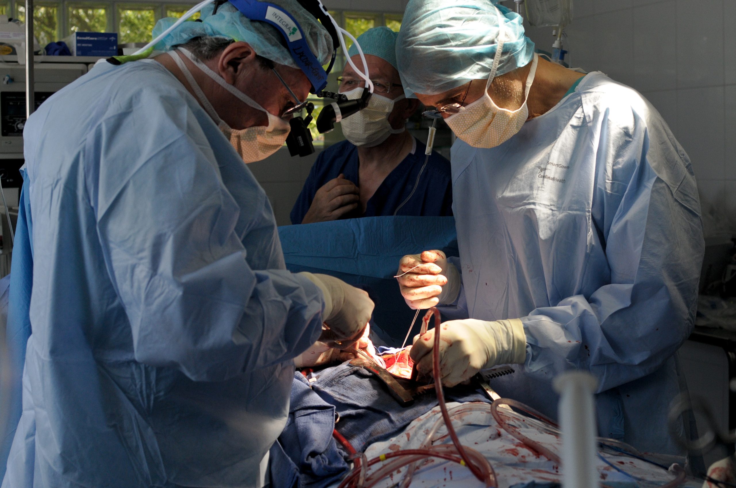 Surgeons Francois Lacour-Gayet (L), of Montefiore Medical Center, and Daniel Roux La of Chaine de L'Espoir, perform surgery to close the hole between the heart chambers of Haitian girl Fabien Destine, 14, in Port-au-Prince April 19, 2012. Eleven children, including Destine, are receiving surgery provided by a mission of pediatric cardiovascular surgeons, doctors and nurses from France's La Chaine de L'Espoir and the Montefiore Medical Center in New York. Among Haiti's population of 10 million, health officials estimate there are around 10,000 cases of rheumatic and congenital heart disease, which according to the World Health Organization are the number one cause of death globally. Picture taken April 19, 2012. REUTERS/Swoan Parker (HAITI)